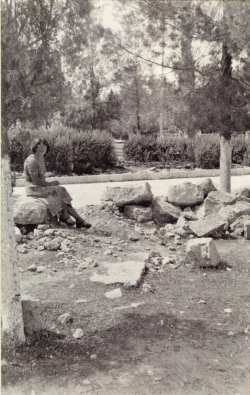 Woman standing on remnant of Beit ha-Miqdash ha-Rishon wall, after